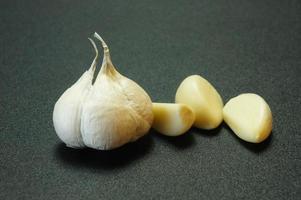 Black isolated photo of onion and garlic