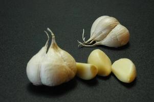 Black isolated photo of onion and garlic