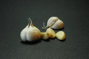 Black isolated photo of onion and garlic