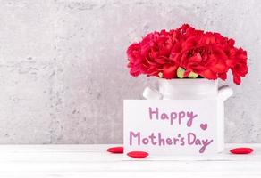 May mothers day handmade giftbox wishes photography - Beautiful blooming carnations with red ribbon box isolated on fair-faced gray background desk, close up, copy space, mock up photo