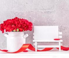 May mothers day handmade giftbox wishes photography - Beautiful blooming carnations with red ribbon box isolated on fair-faced gray background desk, close up, copy space, mock up photo