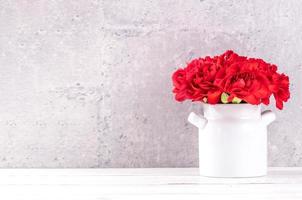 May mothers day handmade giftbox wishes photography - Beautiful blooming carnations with red ribbon box isolated on fair-faced gray background desk, close up, copy space, mock up photo