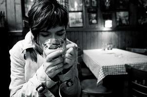 Woman drinking a hot coffee at the diner photo