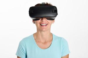 Woman looking in VR glasses and gesturing with his hands. photo