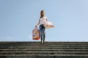 Young woman carrying some shopping bags outdoors photo