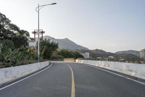 A city road in the front leads to the distance photo