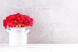 May mothers day handmade giftbox wishes photography - Beautiful blooming carnations with red ribbon box isolated on fair-faced gray background desk, close up, copy space, mock up photo