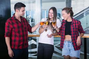 Mates standing and clanging beer photo