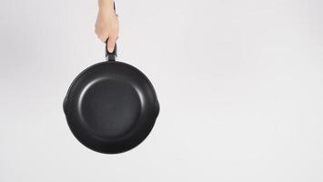 Hand cleaning the non stick pan with handy dish washing sponge photo