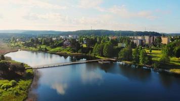 Rising aerial view scenic Lithuania countryside view Ignalina town and Paplovnis lake panorama video