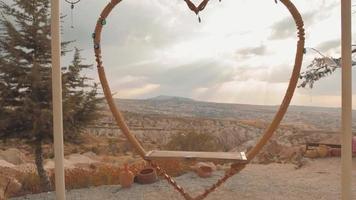 Close up static view heart beautiful swings swinging in slow motion with no person on viewpoint in Cappadocia, Turkey video