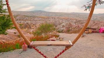 Slow motion view of heart shape wooden swings with nobody around in scenic valley video