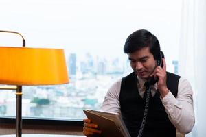 A young businessman monitors and keeps track of tasks in his office