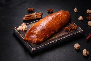 Delicious fresh roll with apricot jam on a dark concrete background photo
