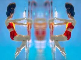 unbelievable, surreal, incredible, amazing underwater portrait of slim, fit woman in bright orange swimming suit photo