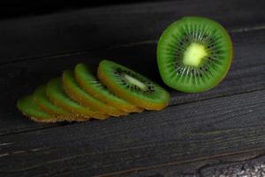 Kiwi fruit on wooden background with copy space photo