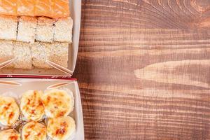 Photo of food. Japanese food rolls on a wooden background.