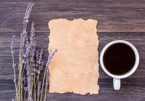 Old paper and coffee on dark wooden table background. photo