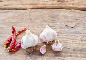 Garlic and dry chili on wooden background