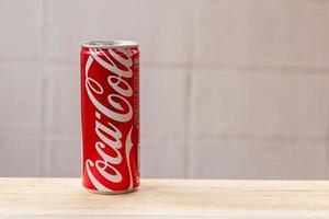 Coca Cola can on wooden table