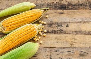 Fresh corn on wooden table background photo