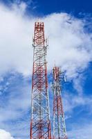 Antenna and cellular tower in blue sky photo