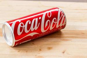 Coca Cola can on wooden table