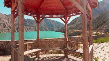 Cinematic zoom in view wooden terrace design rest stop by road with scenic panoramic frame view to Turkey sunny mountains video