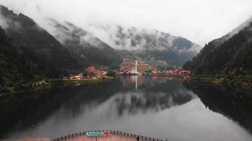 Fly over backwards reveal beautiful lake in Uzungol misty mountains village, Trabzon, Turkey video