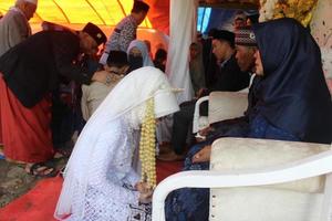 Cianjur Regency, West Java, Indonesia on June 12, 2021, sungkem culture at weddings. Sungkem is the apology of a married child to his parents. photo
