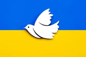 National flag of Ukraine background with a dove of peace. No war concept photo