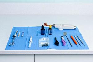 Table with a sterile tablecloth with tools for a dentist photo