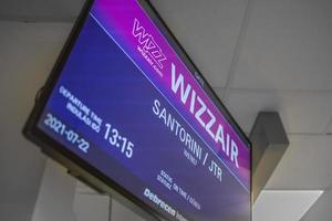 07.22.21 Santorini, Greece close up view of departure screen in Santorini airport. Wizzair low coast airlines. Arrival time, gate. Screen of travel sign photo