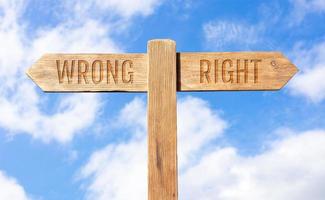 Wrong or right concept. Wooden signpost with message on sky background photo