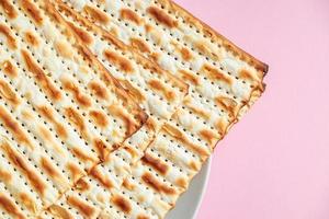 Happy Passover. Matzo on a pink background. photo