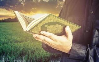 Koran in hand - holy book of Muslims  public item of all muslims photo