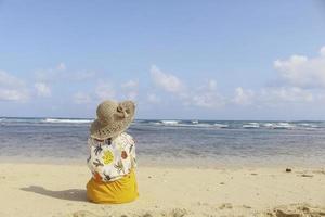 Portrait of happy smiling Asian woman enjoys a holiday at the beach. photo