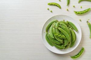 fresh sweet green peas on plate photo