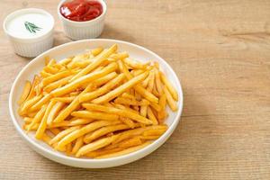 French fries with sour cream and ketchup photo