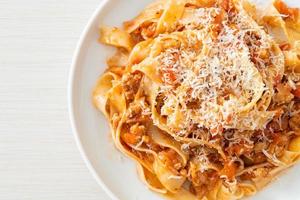 Homemade pasta fettuccine bolognese with cheese photo
