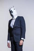 man with a horse mask on a light background photo