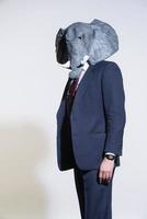 man with an elephant mask on a light background photo