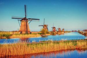 The road leading to the Dutch windmills from the canal photo