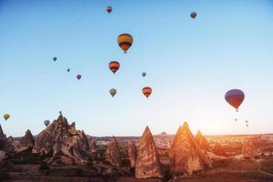 Amazing sunset over Cappadocia. Beautiful color balloons. Turkey photo