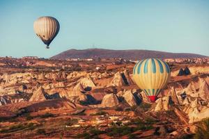 Hot air balloon flying over rock landscape at Cappadocia Turkey. photo