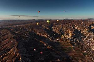 Hot air balloon flying over rock landscape at Cappadocia Turkey. photo