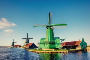 Traditional Dutch windmills from the channel Rotterdam. Holland. photo