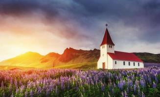 Lutheran church in Vik. The picturesque landscapes of forests an photo