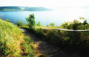 Fantastic views of the trail on the hill leading to the picturesque lake. photo