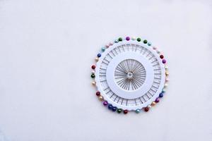 Multicolored needles and hairpins on a white background photo